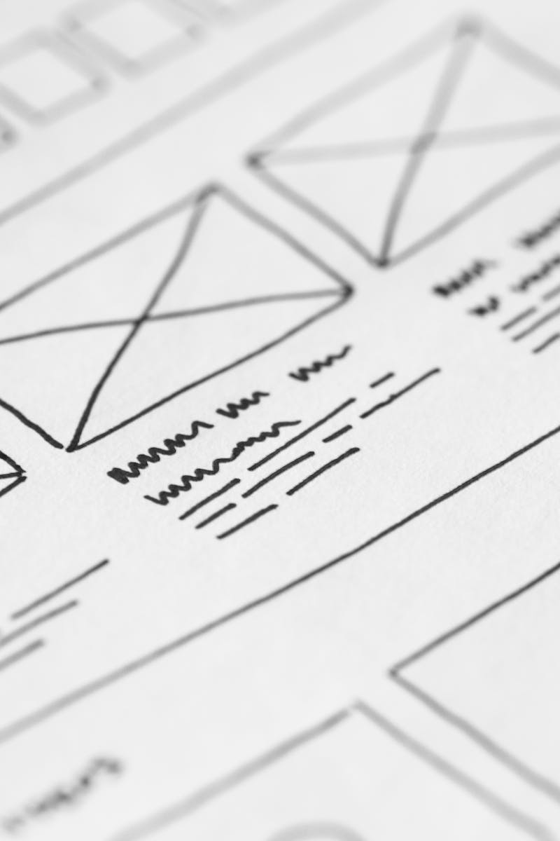 Detailed close-up of a hand-drawn wireframe design on paper for a UX project.